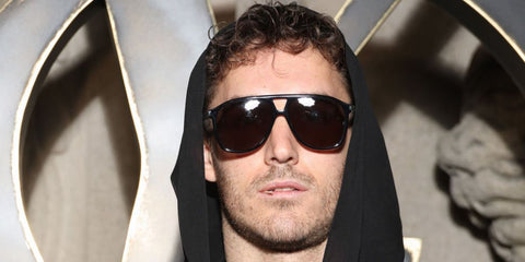 David Alexander Flinn was seen wearing black Saint Laurent Sun SL 596 Dune 001  aviator sunglasses at the Saint Laurent Fall/Winter 2023 fashion show during Paris Fashion Week.