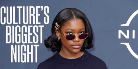 Demi Singleton was seen wearing brass gold Miu Miu MU 52YS 7OE01T oval sunglasses with brown lenses to attend the 2023 BET Awards