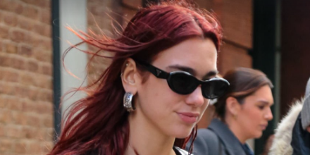 Dua Lipa wearing black Prada symbole sunglasses