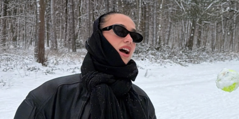 Dua Lipa was seen wearing black Prada PR 26ZS 16K08Z sunglasses in her Instagram post, January 2026.