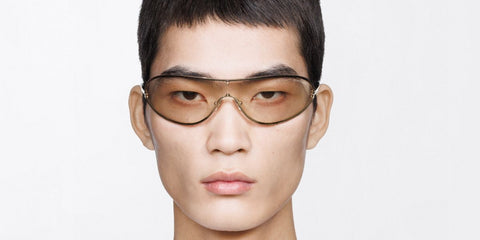 Male model wears Tom Ford Brady-02 TF1396 32C gold metal wraparound sunglasses