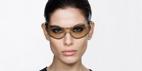 Female model wears Tom Ford Brady-02 TF1396 32C gold metal wraparound sunglasses