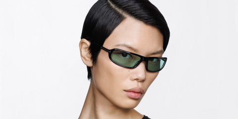 Female model wears Tom Ford Addison-02 TF1400 01N black wraparound sunglasses with green lenses