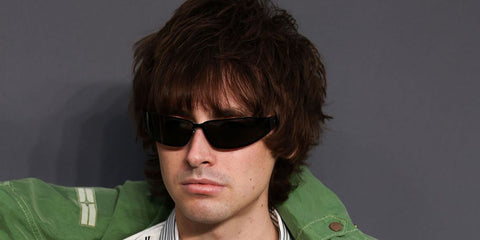 Gene Gallagher was seen wearing black Saint Laurent Sun SL 963 001 wraparound sunglasses at the UK premiere of Oasis: Don't Look Back in Anger, September 2026.