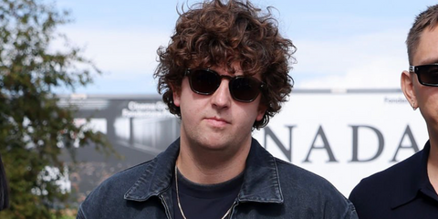 Producer, DJ, and musician Jamie xx was seen wearing black Prada PR A16S 16K731 sunglasses at the Prada Spring/Summer 2026 fashion show during Milan Fashion Week.