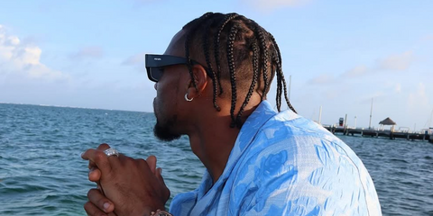 American football player Jonathan Owens of Indianapolis Colts (then Chicago Bears) was seen wearing black and white Prada PR 06YS 09Q5S0 square sunglasses in Belize, shred through his Instagram post in April 2024.