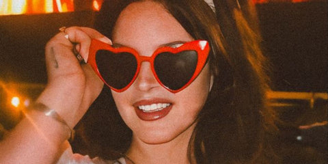 Lana Del Rey is seen wearing Saint Laurent Sun SL 181 LouLou 002 heart shaped sunglasses