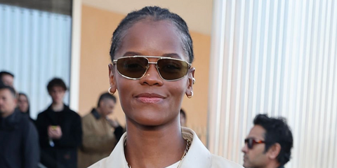 Letitia Wright was seen wearing gold Prada PR C51S 5AK70G sunglasses with olive lenses at the Prada Fall/Winter 2026 fashoin show during Milan Fashion Week.