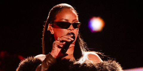 Rihanna was seen wearing black Saint Laurent Sun SL 963 001 wraparound sunglasses onstage during Jay-Z's Reasonable Doubt 30th Anniversary Celebration concert in New York City, July 2026.
