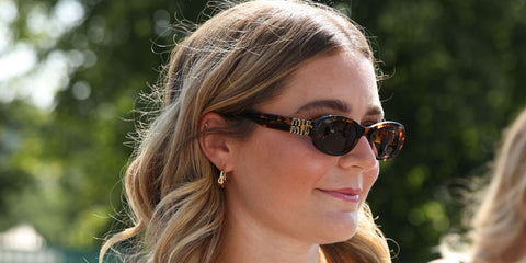 Tilly Ramsay was seen wearing tortoiseshell Miu Miu MU 06ZS VAU06B oval sunglasses at the Wimbledon Tennis Championships 2026.