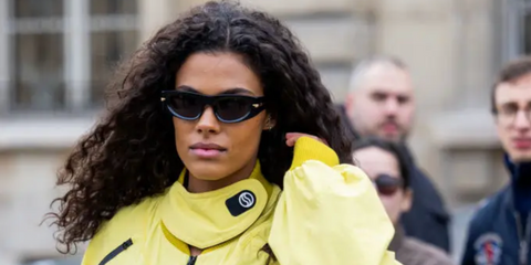 Tina Kunakey was seen wearing Bottega Veneta BV1144S 001 cat eye sunglasses to attend Stella McCartney Fall/Winter 2023 fashion show during Paris Fashion Week