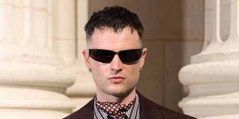 Tom Sturridge was seen wearing black Saint Laurent Sun SL 963 001 wraparound sunglasses at the Saint Laurent Menswear Spring/Summer 2027 fashion show during Paris Men's Fashion Week